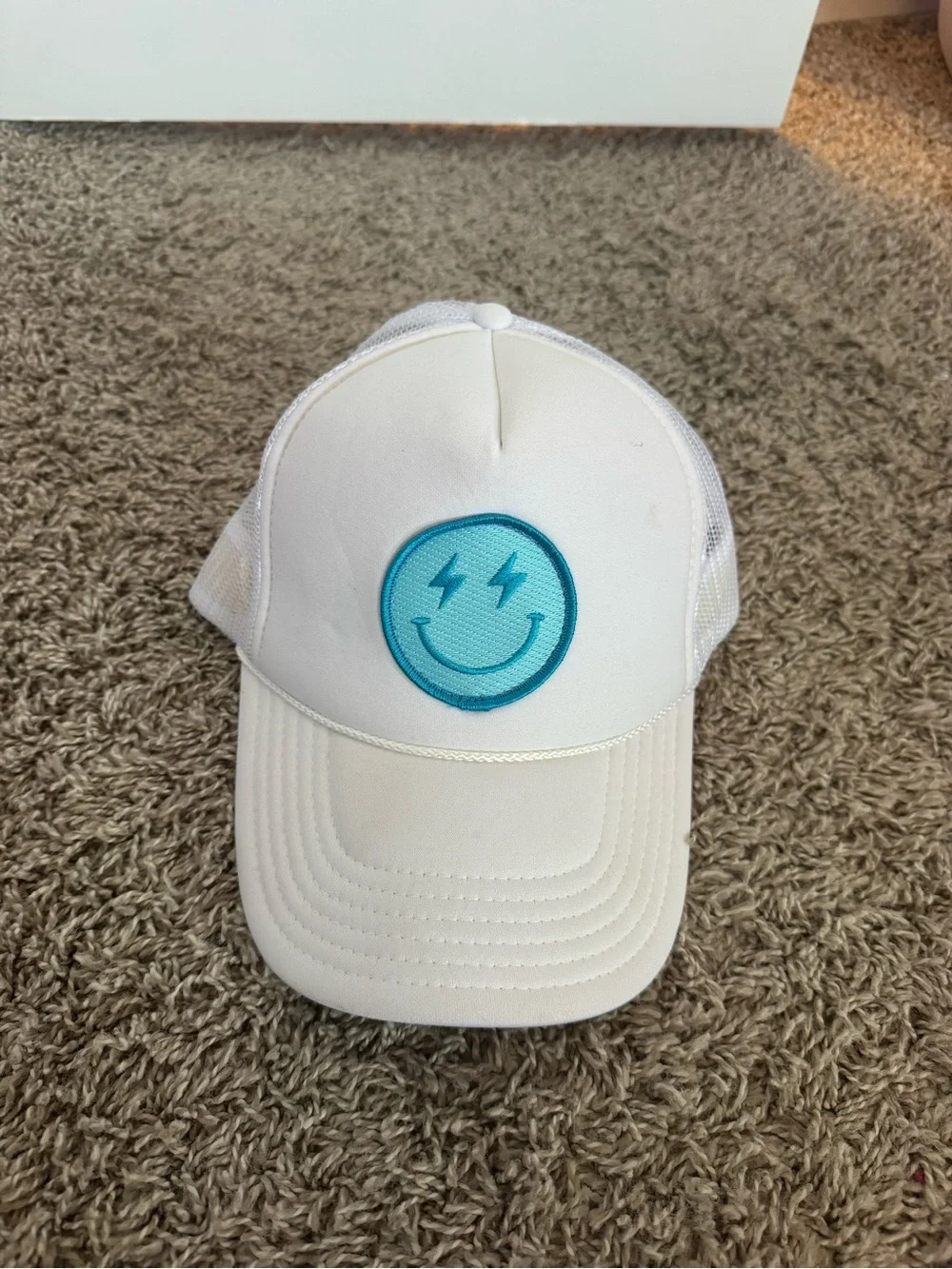 White Trucker Hat with Teal Smiley Patch